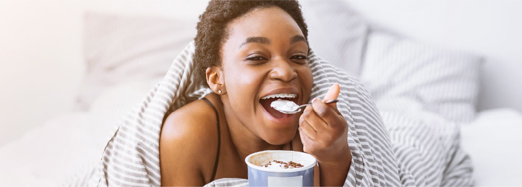 Girl Eating Ice Cream in Bed